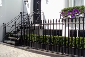 Custom made classic style entry staircase balustrade and cast iron railings
